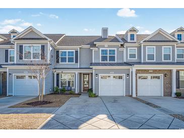 Charming townhomes with gray siding, white trim, and well-manicured lawns create curb appeal at 2404 Thoroughfare Dr. # 2404, North Myrtle Beach, SC 29582