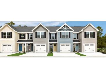 Four-unit townhome building, showcasing multiple exterior finishes and two-car garages at 261 Christiana Ln. # B, Myrtle Beach, SC 29579