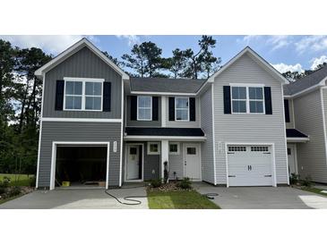 Charming two-story townhome with gray siding, black shutters, and attached garages at 265 Christiana Ln. # F, Myrtle Beach, SC 29579