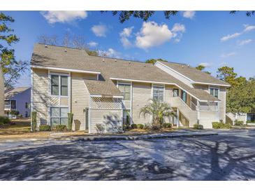 Attractive exterior of a two-story condo building with ample parking at 4434 Little River Inn Ln. # 205, Little River, SC 29566