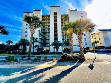 Beach Club building exterior with palm trees and ample parking at 4505 S Ocean Blvd. S # 1-E, North Myrtle Beach, SC 29582