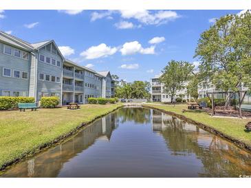 Waterfront community with buildings, picnic tables, and a playground at 5905 S Kings Hwy. # 6312, Myrtle Beach, SC 29575