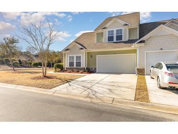 Two-story townhome with attached garage and manicured lawn at 6172 Catalina Dr. # 911, North Myrtle Beach, SC 29582