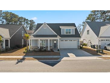 Charming craftsman style home with gray siding, stone accents, and a two-car garage at 1113 Mary Read Dr., North Myrtle Beach, SC 29582