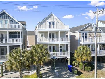 Stunning multi-story beach house featuring triple balconies and ample parking space at 1514-A S Ocean Blvd., Surfside Beach, SC 29575
