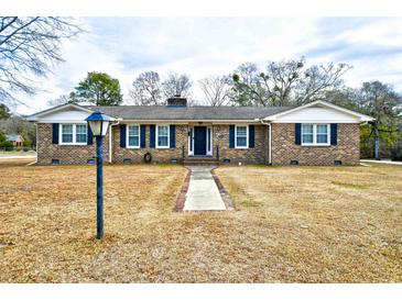 Brick ranch house with a landscaped yard and walkway at 155 Busbee St., Conway, SC 29526