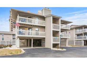 Three-story building with multiple units, balconies, and parking underneath at 1801 N Ocean Blvd. # F-1, North Myrtle Beach, SC 29582