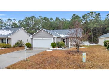 Gray house with a white garage door and small front yard at 184 Retreat Pl., Little River, SC 29566