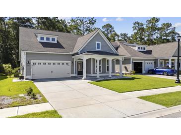 Gray two-story house with a large front yard and two-car garage at 2360 Goldfinch Dr., Myrtle Beach, SC 29577