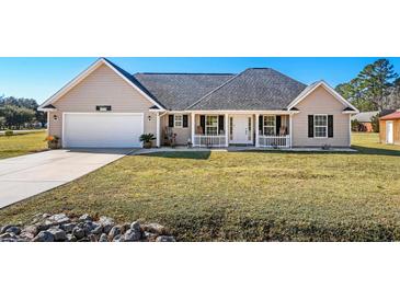 One-story house with attached garage and landscaped yard at 2579 Allen Dew Rd., Conway, SC 29527