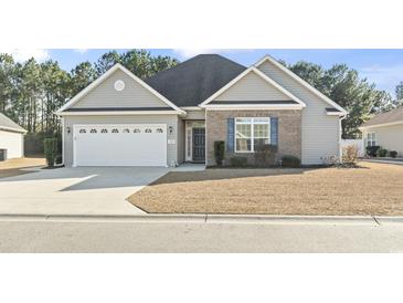 Gray siding house with a two-car garage and manicured lawn at 308 Turning Pines Loop, Myrtle Beach, SC 29579