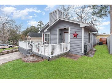 Gray house with white railing and small front yard at 4306 Princeton Dr., Little River, SC 29566