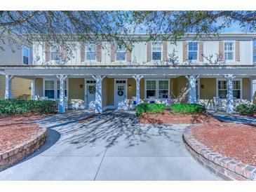 Two-story home with front porch and landscaping at 4910 N Market St. # M9-R2, North Myrtle Beach, SC 29582