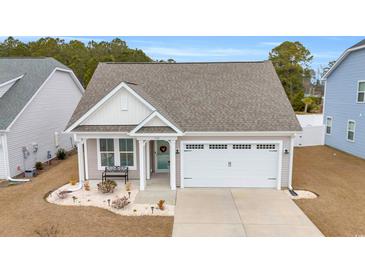 Attractive Craftsman style home with a two-car garage and landscaped front yard at 520 Shellbark Dr., Longs, SC 29568