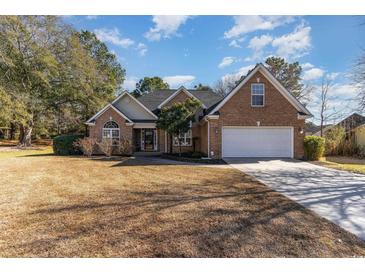 Brick home with two-car garage and landscaped lawn at 604 Ellis Dr., Conway, SC 29526