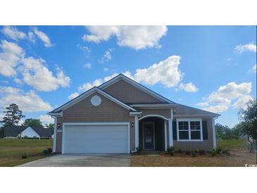 Charming single-story home with a two-car garage, neutral siding, and a well-manicured lawn at 705 Choctaw Dr., Conway, SC 29526