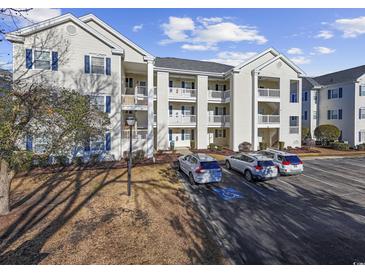 Attractive condo building featuring multiple stories and private balconies, surrounded by well-kept landscaping and ample parking at 901 West Port Dr. # 1706, North Myrtle Beach, SC 29582