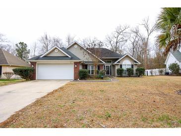 Brick ranch home with attached garage and landscaped lawn at 1047 Rose Haven Dr., Conway, SC 29527