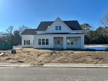 Newly constructed home with white siding, gray roof, and covered porch at 1201 Possum Trot Rd., North Myrtle Beach, SC 29582