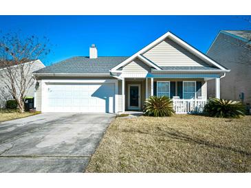 Tan house with white garage door and porch at 1288 Brighton Ave., Myrtle Beach, SC 29588