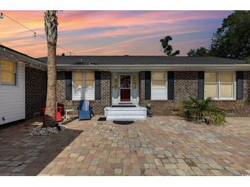 Brick ranch home with inviting front patio and landscaping at 1530 Deer Park Ln., Surfside Beach, SC 29575