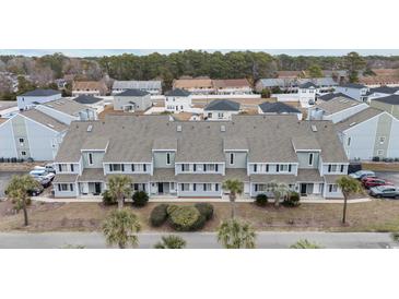 Aerial view of townhouses with gray roofs and light blue siding, surrounded by lush greenery at 1890 Colony Dr. # 17N, Myrtle Beach, SC 29575