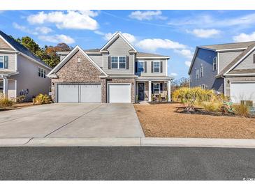 Two-story brick home with a three-car garage and landscaped lawn at 206 Calhoun Falls Dr., Myrtle Beach, SC 29579