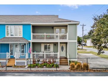 Two-story home with a gray and blue exterior, porch, and landscaping at 2102 S Ocean Blvd. # D, North Myrtle Beach, SC 29582