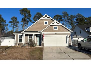 Attractive Craftsman style home with two-car garage and landscaped lawn at 3047 Honey Clover Ct., Longs, SC 29568