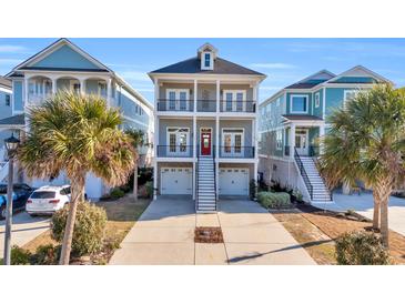 Three-story home with gray siding, red door, and two-car garage at 369 Saint Julian Ln., Myrtle Beach, SC 29579