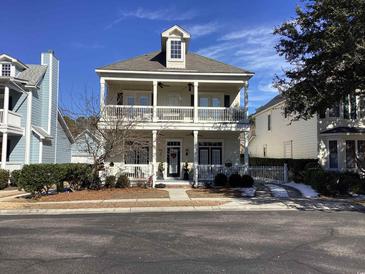 Two-story house with front porch and balcony, landscaped yard at 41 Federation Loop, Pawleys Island, SC 29585