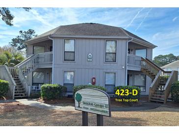 Two-story building with gray siding, multiple entrances, and stairs at 423 Tree Top Ct. # 23-D, Myrtle Beach, SC 29588