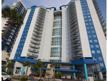 Modern high-rise building with blue and white accents, located near palm trees and a Starbucks at 504 N Ocean Blvd. # 1003, Myrtle Beach, SC 29577