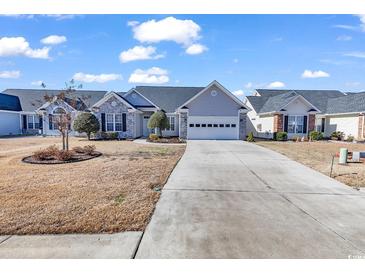 Single-story home with gray siding, brick accents, and a two-car garage at 541 Sand Ridge Rd., Conway, SC 29526