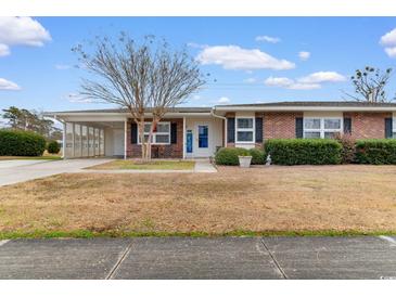 Brick ranch house with carport and landscaped yard at 676 Pelican Ave. # 676, Myrtle Beach, SC 29577