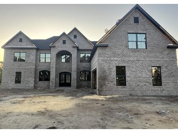 Elegant brick house with symmetrical design and modern windows offers classic charm and contemporary appeal at 7053 Byrnes Ln., Myrtle Beach, SC 29588