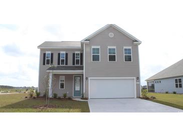 Two-story house with gray siding, a two-car garage, and landscaping at 7073 Shooting Star Way, Myrtle Beach, SC 29579