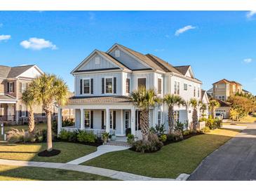 Two-story light blue house with palm trees and a stone walkway at 744 Crystal Water Way, Myrtle Beach, SC 29579