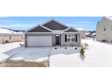 Gray siding house with white garage door and snow covered lawn at 275 Columbus St., Conway, SC 29526