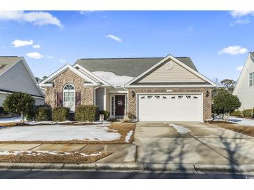 Brick ranch home with attached garage and landscaped yard at 3141 Shorecrest Bay Dr., Murrells Inlet, SC 29576