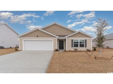 New construction home with tan siding, white garage door and landscaping at 3480 Ashridge Way, Conway, SC 29526