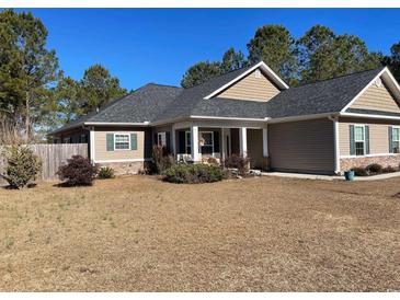 House exterior featuring a two-car garage and landscaped yard at 430 Long Lake Circle, Conway, SC 29527