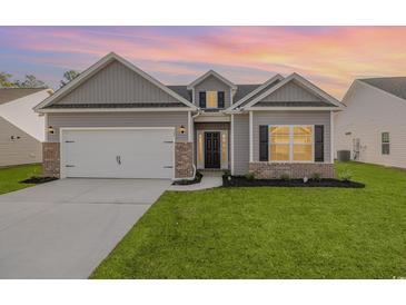 Charming craftsman style home with gray siding and brick accents at 431 Lifestyle Court, Surfside Beach, SC 29575