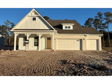 Two-story home with white siding, gray roof and two-car garage at 45 Northbrook Dr, Murrells Inlet, SC 29576