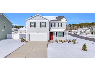 Two-story home with white siding, red door, and snow-covered lawn at 545 Goldstar St., Conway, SC 29526