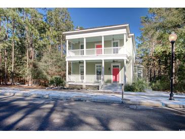 Two-story house with light green exterior, red door, and white columns at 55 Pineberry Dr., Georgetown, SC 29440