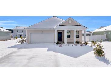 Snow covered home's exterior features a garage and front porch at 708 Canton St., Conway, SC 29526