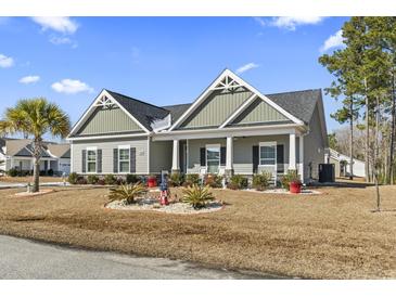 Gray house with white accents, landscaping, and a well-maintained lawn at 901 Queensferry Ct., Conway, SC 29526