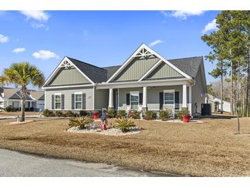 Charming single-story home showcasing a manicured lawn and inviting front porch at 901 Queensferry Ct., Conway, SC 29526