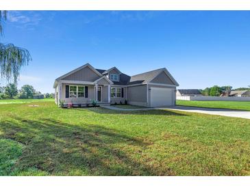 Newly built home with gray siding, attached garage, and grassy yard at Tbd Hodges Rd., Conway, SC 29527